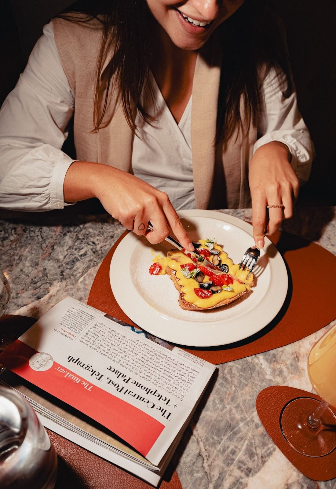 girl eating brunch, french toast with berries and custard cream